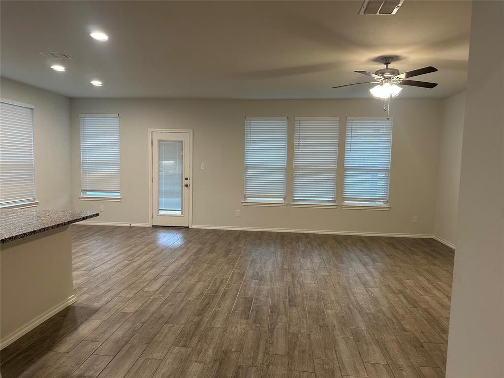 1613 Abbottsford Avenue Providence Village, TX 76227 - Photo 13 of 14 a view of an empty room with a window and wooden floor