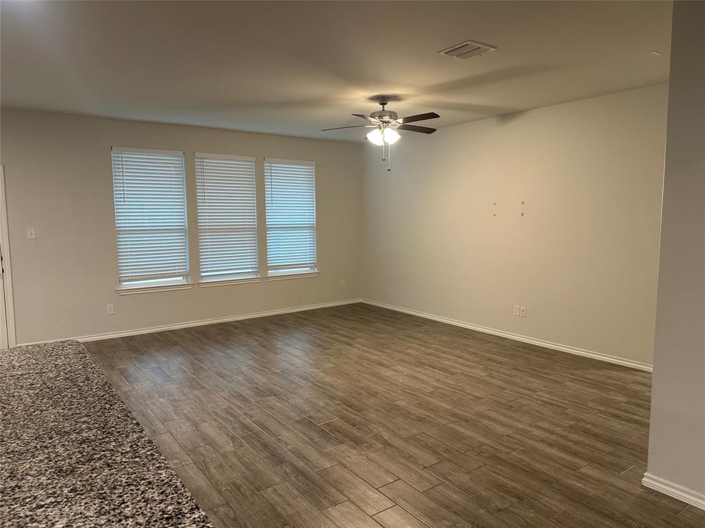1613 Abbottsford Avenue Providence Village, TX 76227 - Photo 14 of 14 a view of empty room with wooden floor and fan