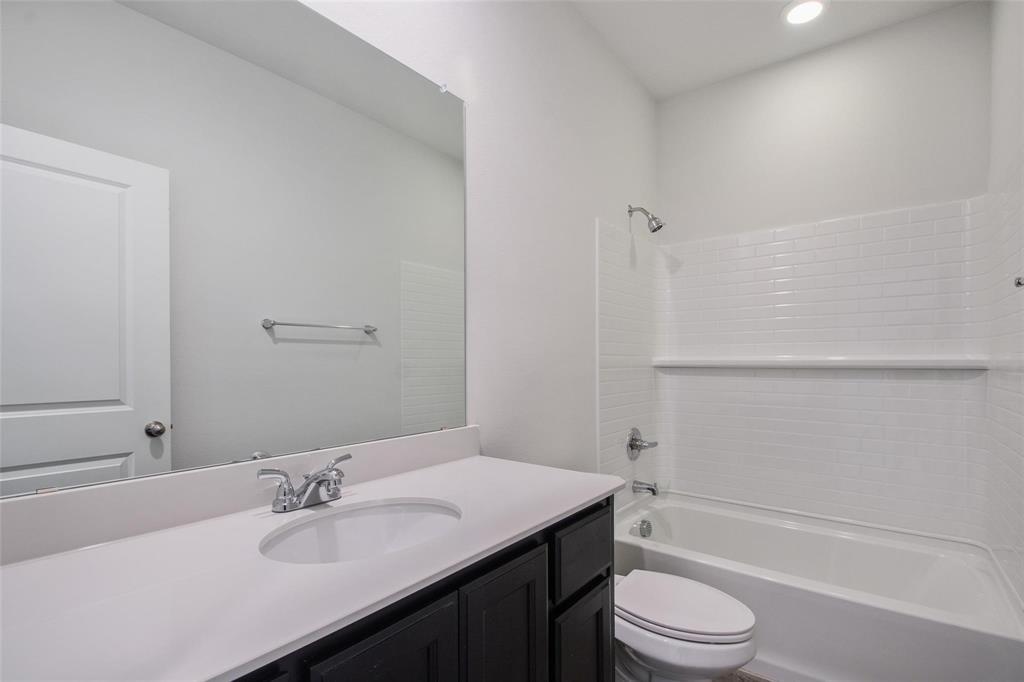 1613 Abbottsford Avenue Providence Village, TX 76227 - Photo 2 of 14 a bathroom with a sink a toilet and shower