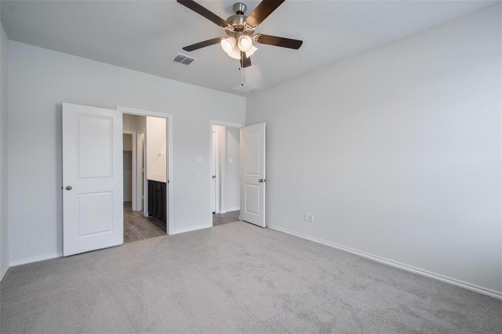 1613 Abbottsford Avenue Providence Village, TX 76227 - Photo 3 of 14 a view of an empty room and a ceiling fan