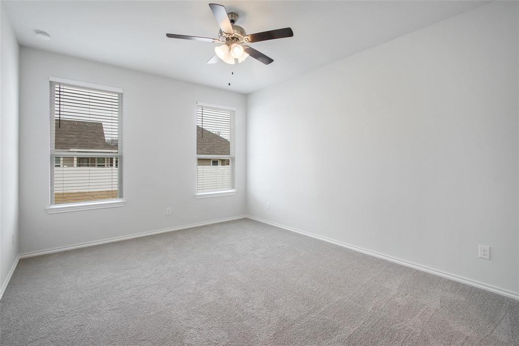 1613 Abbottsford Avenue Providence Village, TX 76227 - Photo 4 of 14 an empty room with windows and fan