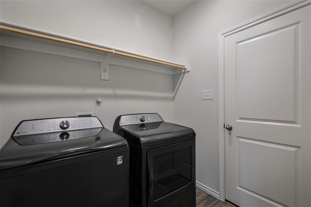 1613 Abbottsford Avenue Providence Village, TX 76227 - Photo 5 of 14 a utility room with dryer and washer