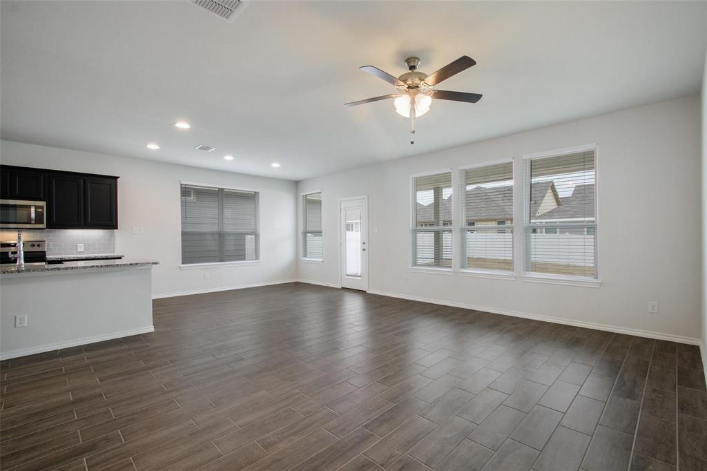 1613 Abbottsford Avenue Providence Village, TX 76227 - Photo 6 of 14 a view of an empty room with window and wooden floor