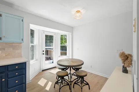 a view of a room with a table and chairs