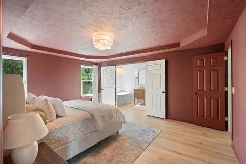 a spacious bedroom with a large bed and a large window