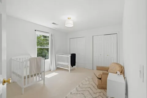 a bedroom with furniture and a window