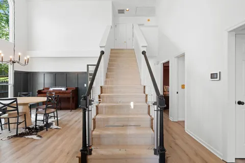 a view of entryway and hall with wooden floor