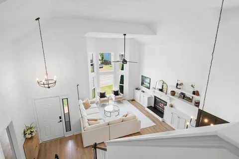 a view of kitchen and living room with wooden floor