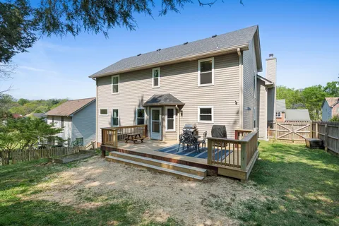 a view of a house with backyard and sitting area