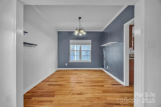 an empty room with windows and ceiling fan