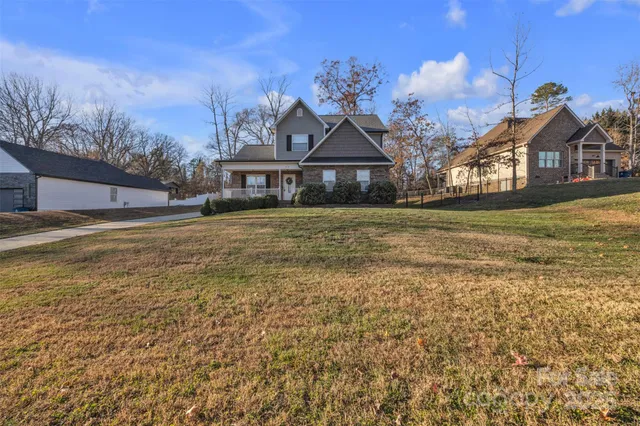 a view of a house with a patio and backyard