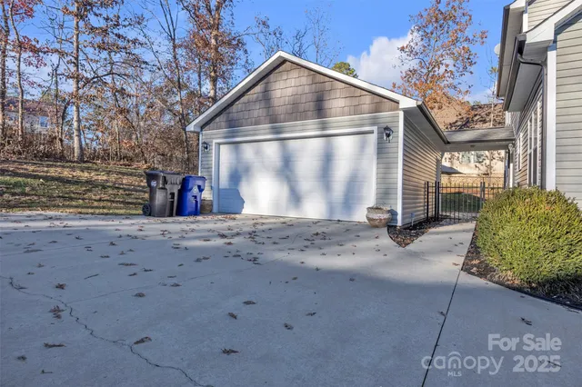 a view of an empty room with cabinet and a window