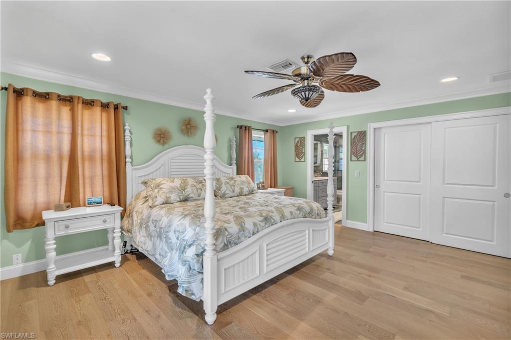 3001 50th Street Southwest Naples, FL 34116 - Photo 12 of 46 a bed room with a bed and a chandelier