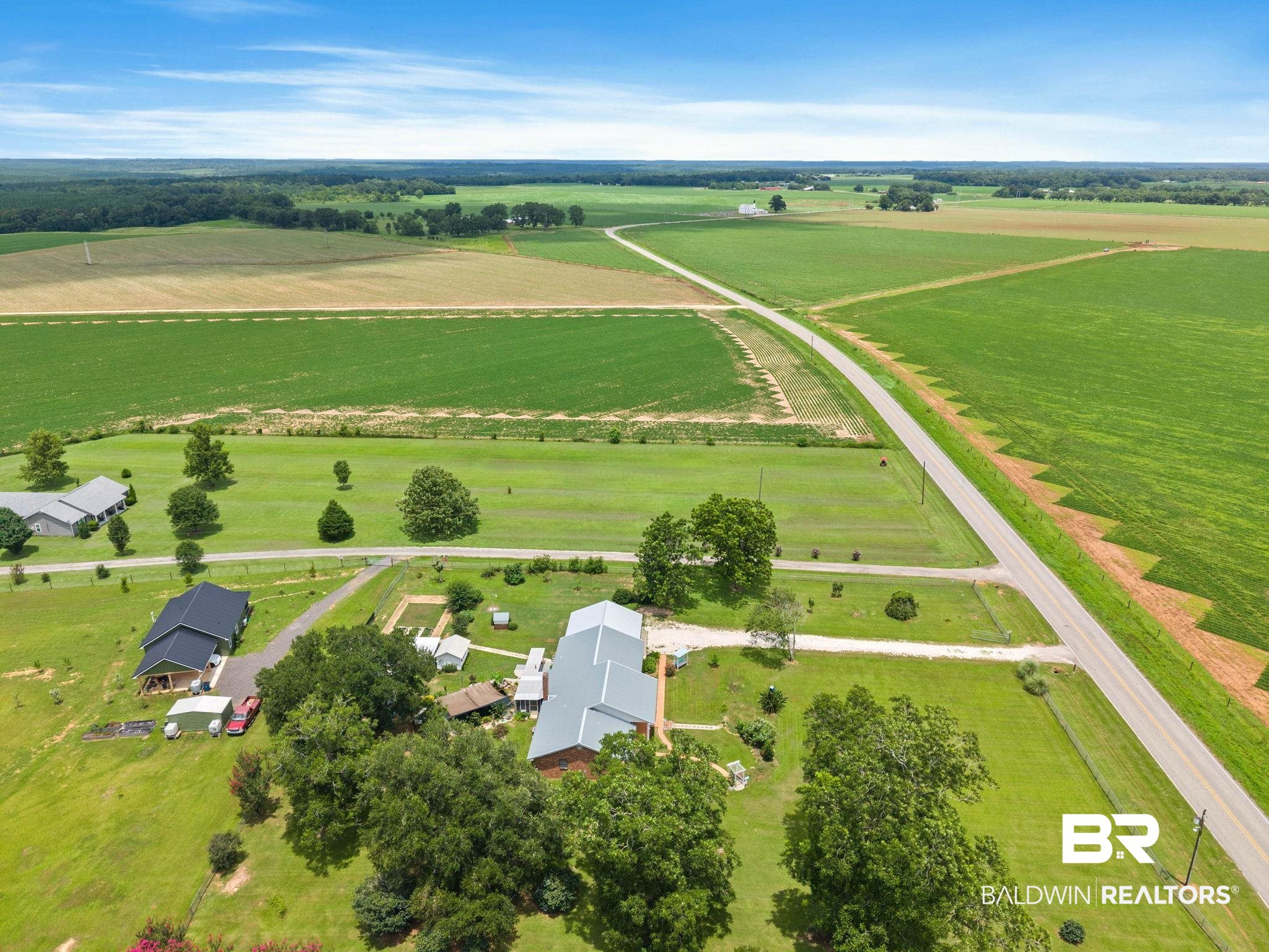 3791 Robinsonville Road Atmore, AL 36502 - Photo 54 of 55 Expansive rural property featuring multiple structures, verdant fields, and mature trees