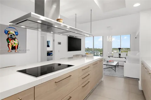 a kitchen with a dining table chairs and white cabinets