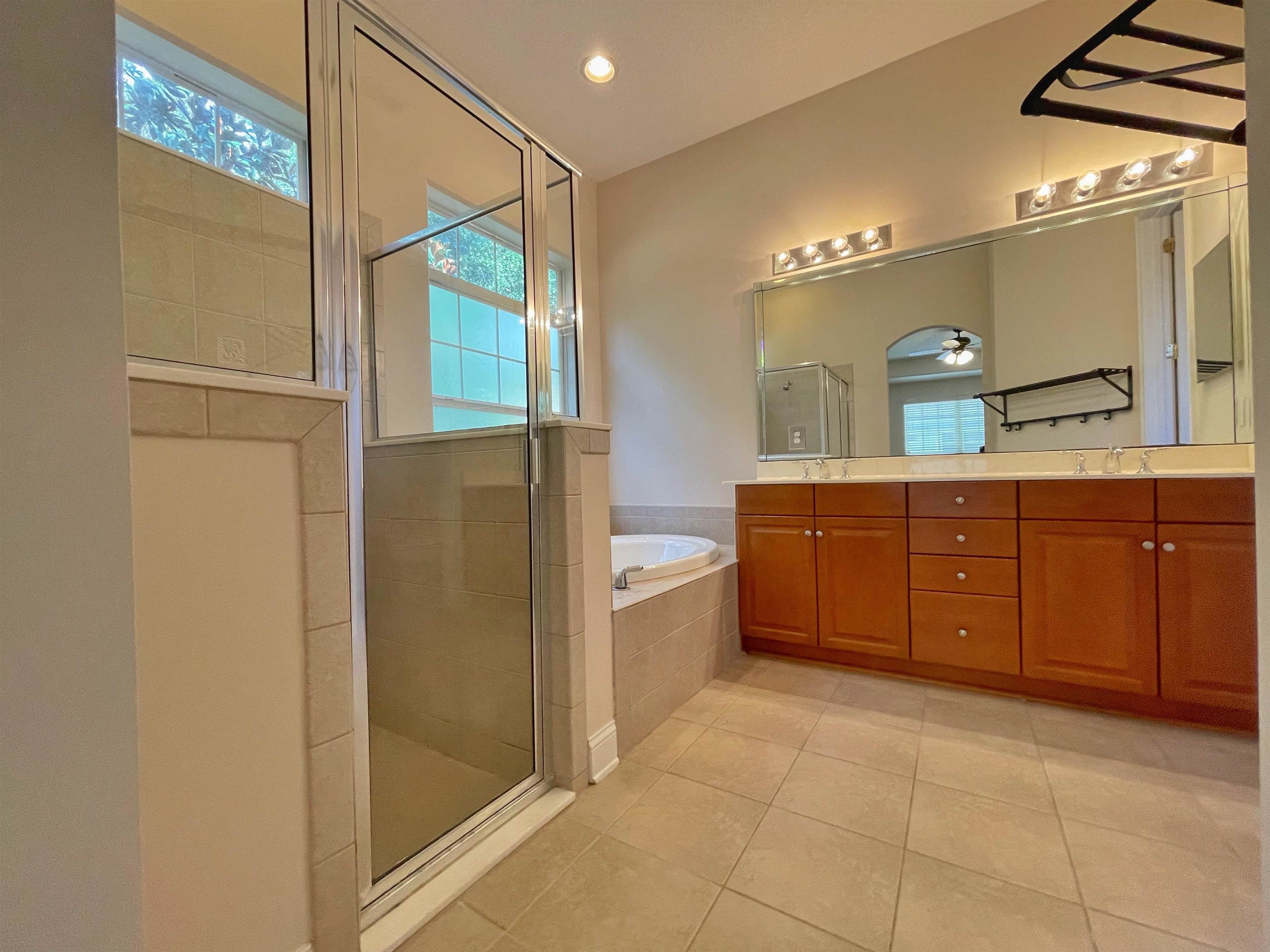 157 West Village Drive St. Augustine, FL 32095 - Photo 17 of 43 a spacious bathroom with a granite countertop sink a mirror and a bathtub