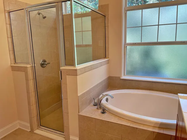 a bath tub sitting next to a shower