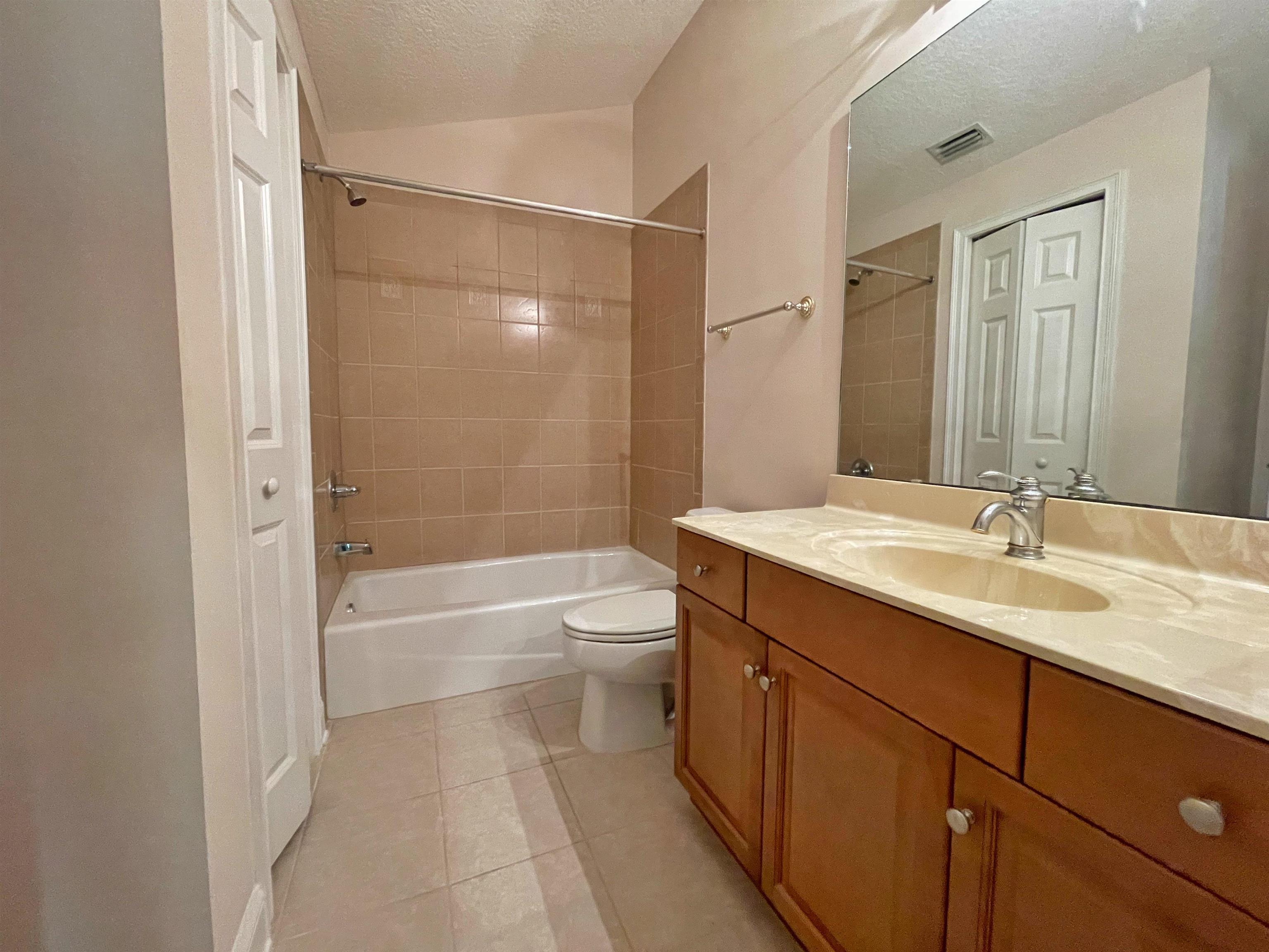 157 West Village Drive St. Augustine, FL 32095 - Photo 29 of 43 a bathroom with a granite countertop sink toilet a shower and a mirror
