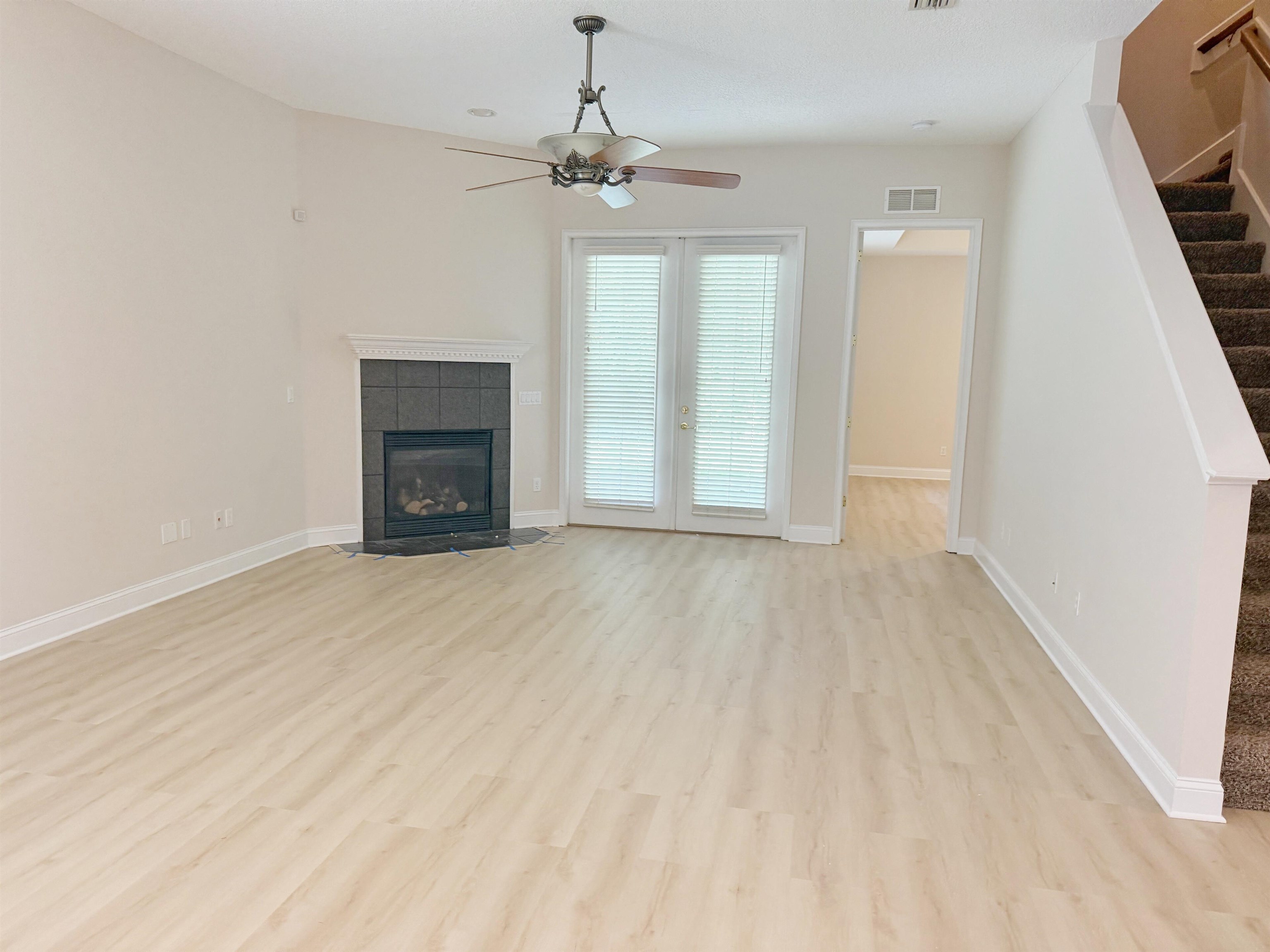 157 West Village Drive St. Augustine, FL 32095 - Photo 5 of 43 wooden floor fireplace and natural light in room