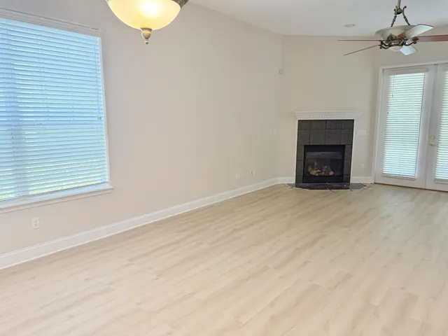 an empty room with a fireplace and window