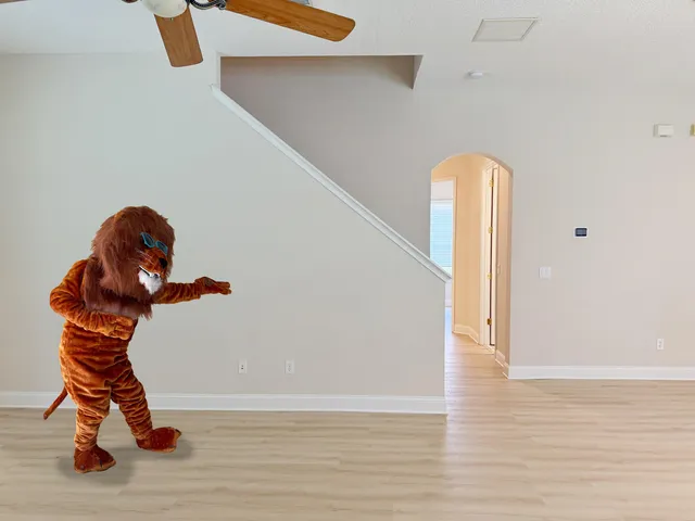 a room with gym equipment and wooden floor