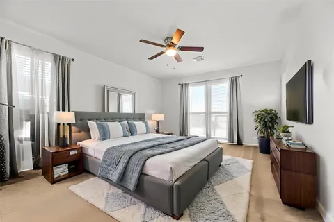 a bed room with a bed and a potted plant