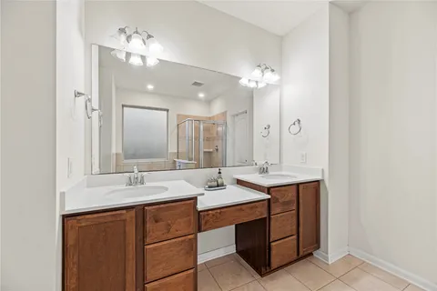 a bathroom with a sink double vanity and a mirror
