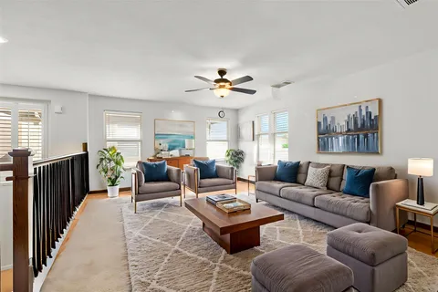 a living room with furniture a chandelier and a window