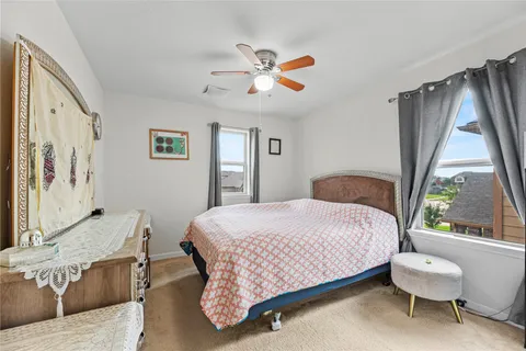 a bedroom with a bed and a large window