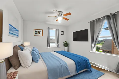 a bedroom with a bed and a flat screen tv