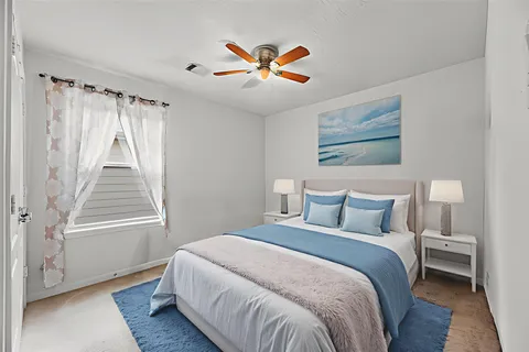 a bedroom with a bed and a window