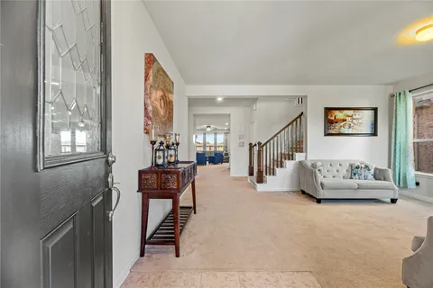 a living room with furniture and stairs