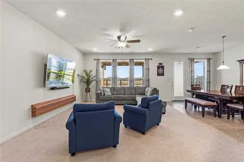 a living room with furniture and a floor to ceiling window