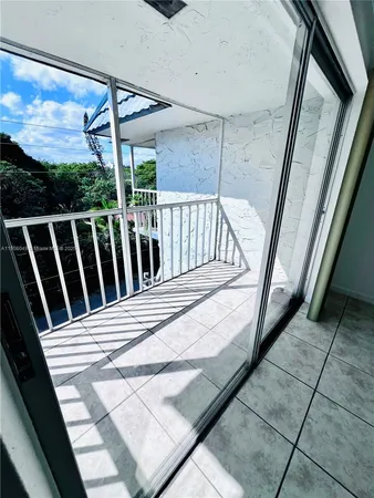 a view of balcony with wooden floor