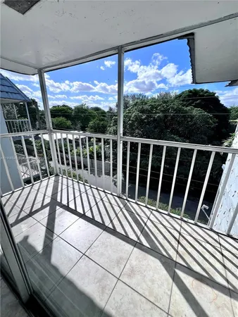 a view of balcony with furniture