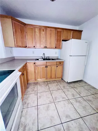 a kitchen with stainless steel appliances a stove a sink and a refrigerator