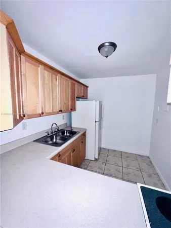 a kitchen that has a sink and a stove