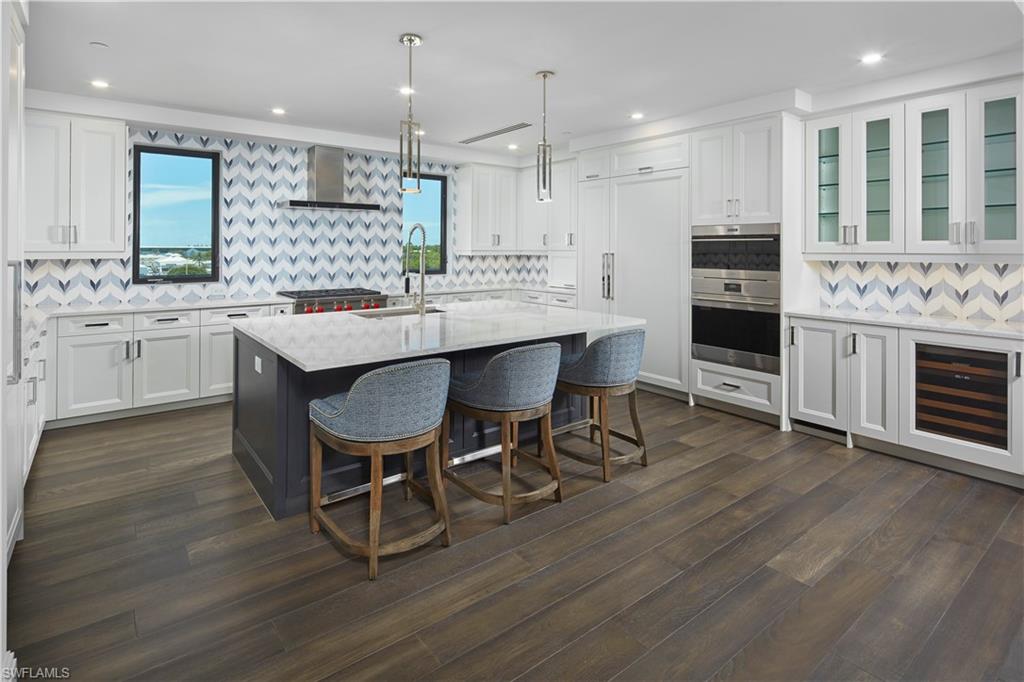 1130 3rd Avenue South, Unit 508 Naples, FL 34102 - Photo 1 of 4 a large kitchen with a table and chairs in it