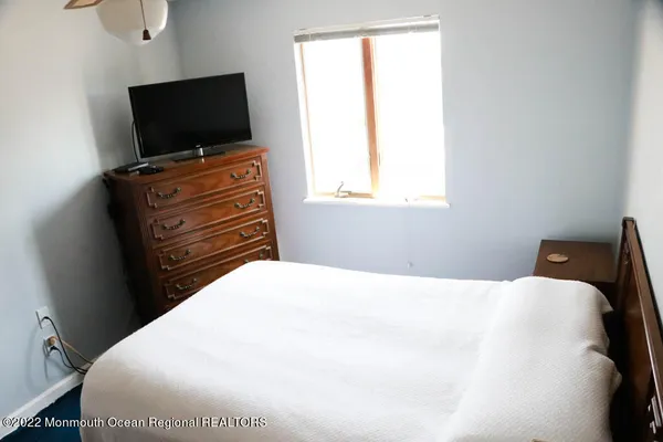 a bedroom with a bed and flat screen tv