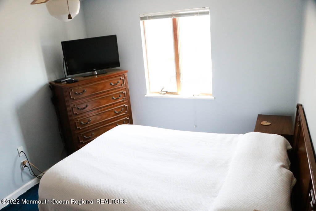 5 Vine Court Long Branch, NJ 07740 - Photo 19 of 30 a bedroom with a bed and flat screen tv