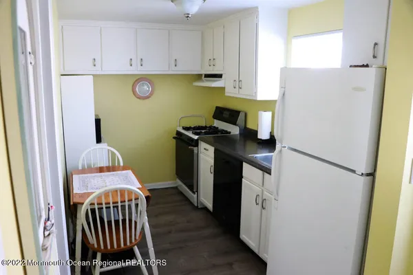 a kitchen with a refrigerator and a stove