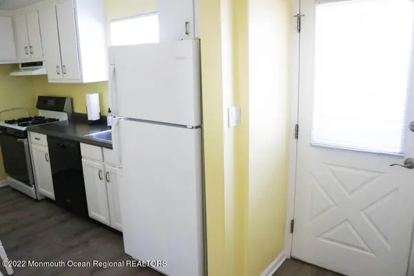 a white refrigerator freezer sitting inside of a kitchen