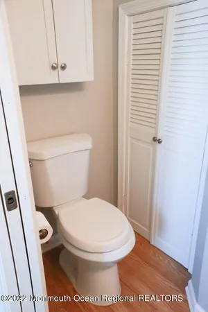 a white toilet sitting next to a sink