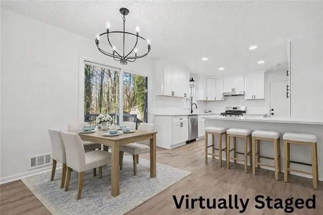 a view of a dining room with furniture window and wooden floor
