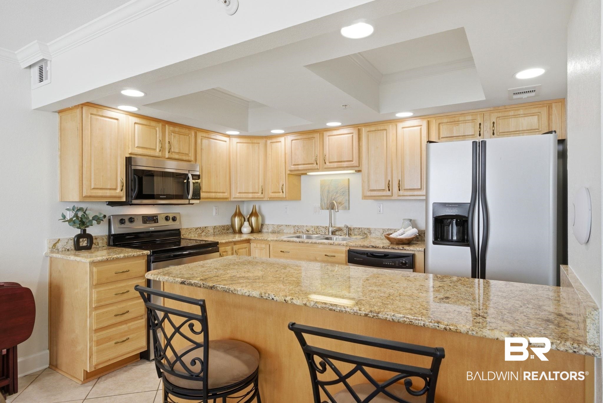 16284 Perdido Key Drive, Unit 912 Perdido Key, FL 32507 - Photo 25 of 49 Kitchen featuring crown molding, light wood finish cabinets, recessed lighting, a kitchen breakfast bar, and stainless steel appliances