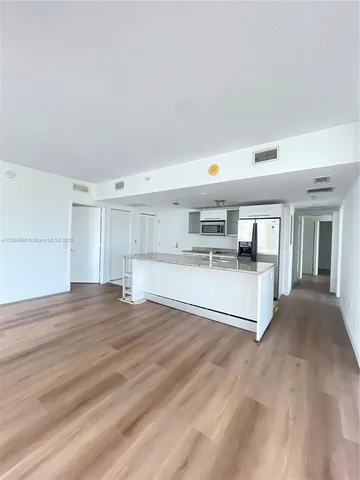 a view of kitchen and wooden floor