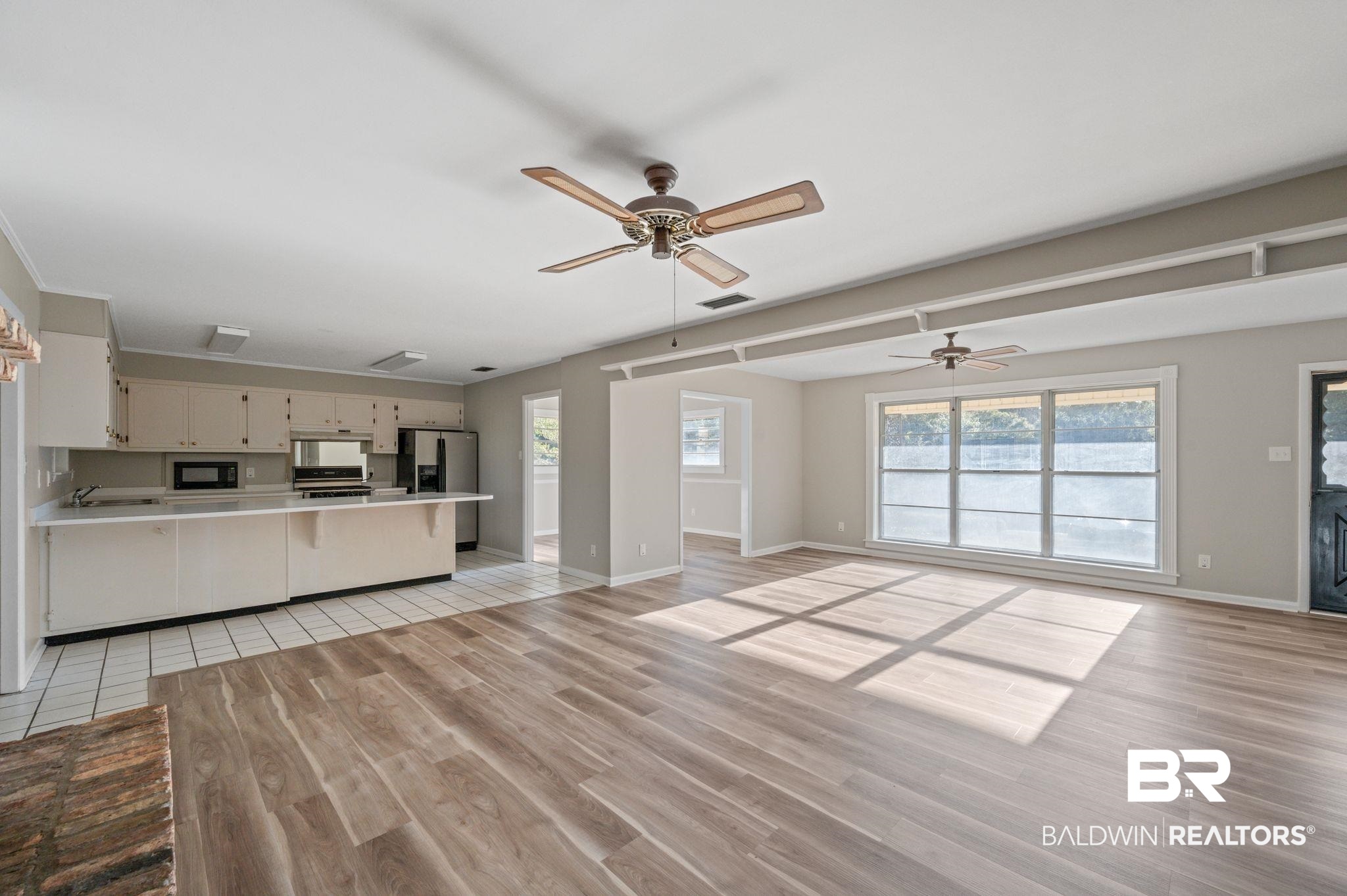 909 Caroline Avenue Daphne, AL 36526 - Photo 13 of 46 Unfurnished living room featuring light hardwood / wood-style flooring and ceiling fan