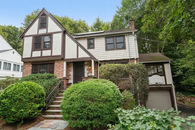 a view of a house with brick walls and potted plants