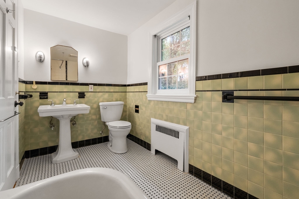 16 Duxbury Road Newton, MA 02459 - Photo 24 of 30 a bathroom with a sink a toilet and mirror