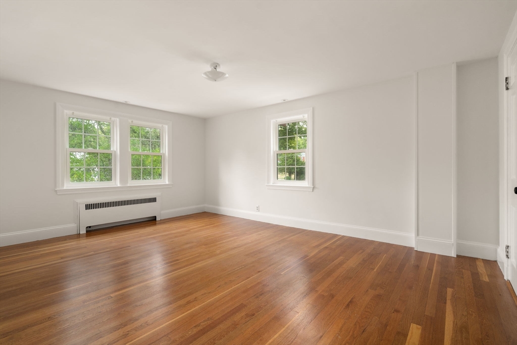 16 Duxbury Road Newton, MA 02459 - Photo 26 of 30 an empty room with wooden floor and windows